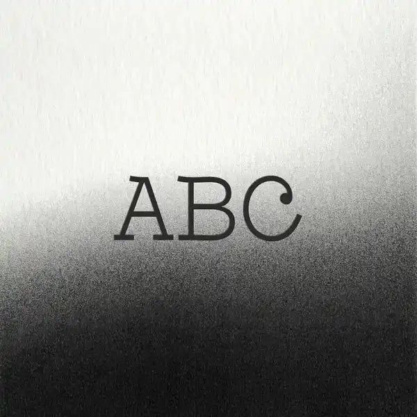 Black serif lettering spelling ’abc’ on a textured gradient background.