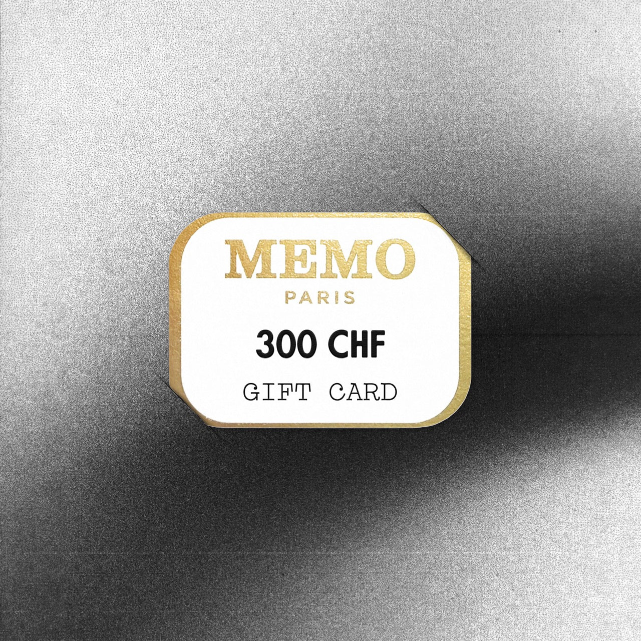 A white and gold memo paris gift card with 300 chf value featuring elegant typography celebrating dream destinations