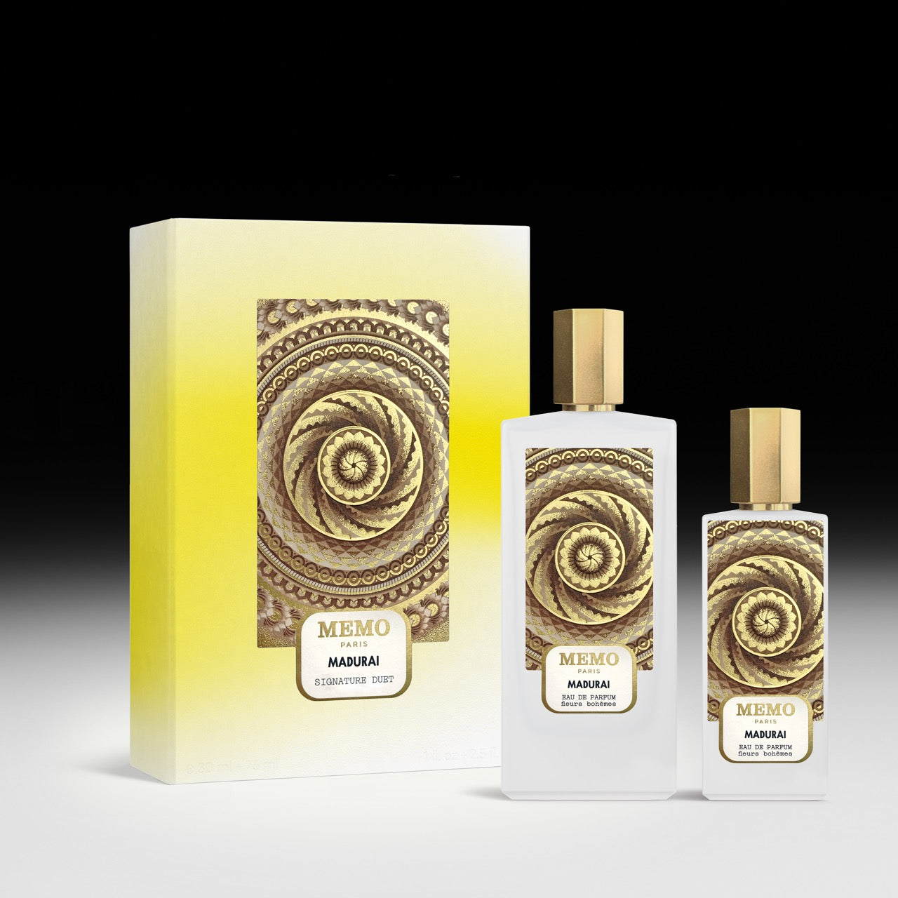 Elegant white glass perfume bottles with gold caps and spiral designs next to matching gradient yellow box signature duet madurai
