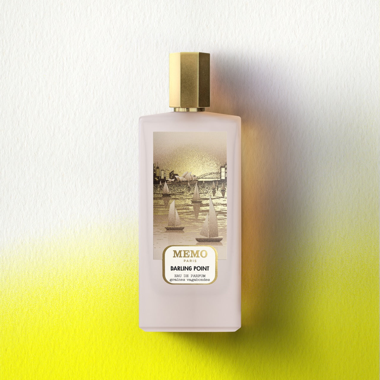 A pale pink rectangular perfume bottle with a gold cap and sailboats label from memo paris darling point essences set
