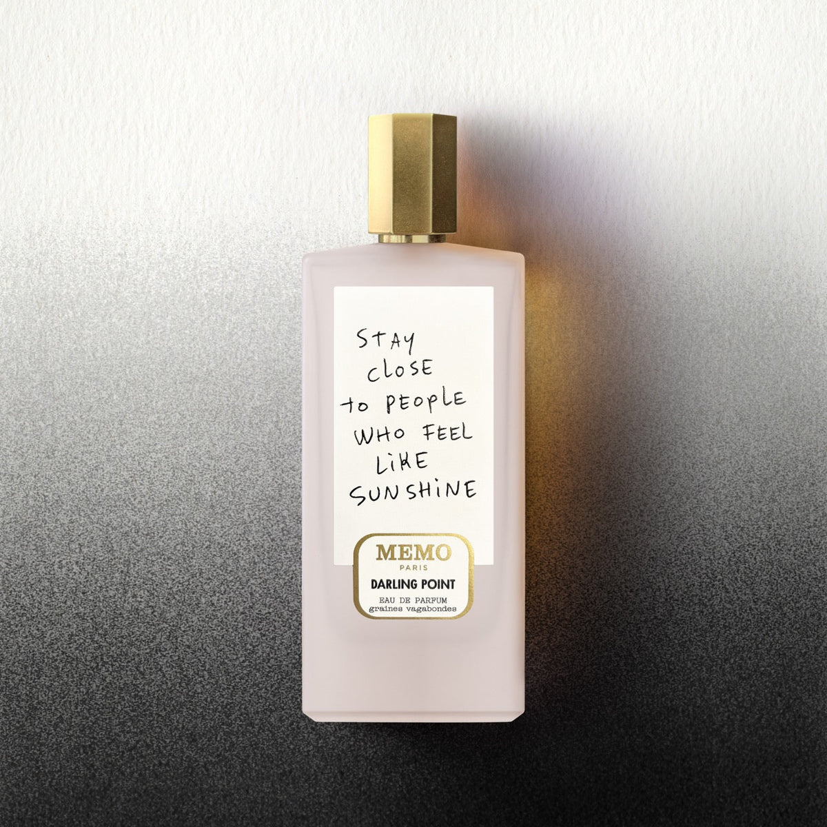 A pale pink rectangular perfume bottle with gold cap and memo paris label by darling point x thomas lelu white