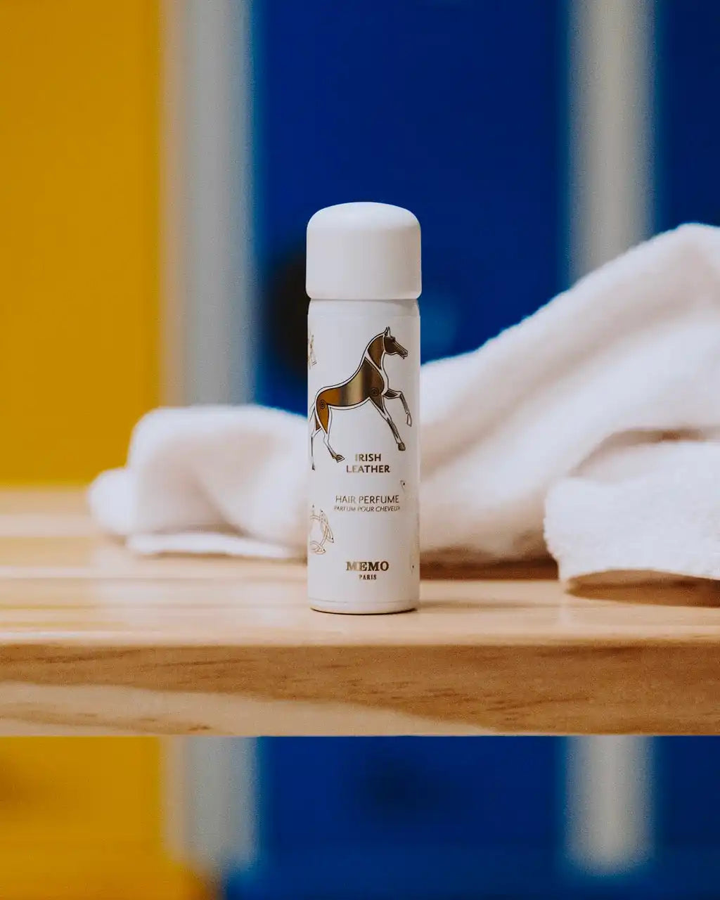 White perfume bottle with horse illustration.